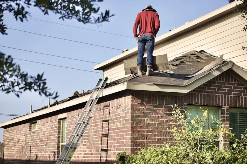 Professional roofer working on a residential roof in New Irving Park